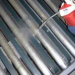 Cleaning conveyor systems in latex factory